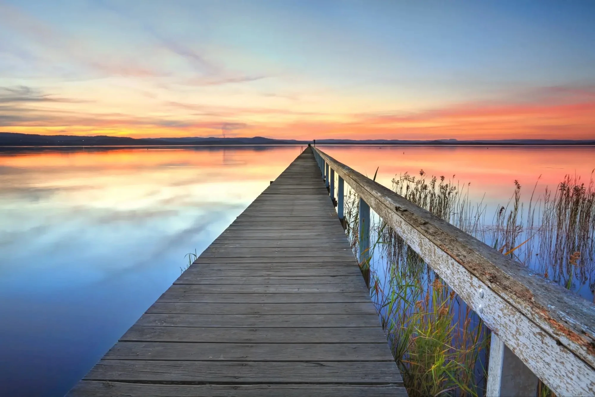 Calm Tuggerah jetty at sunset with still water on the Central Coast