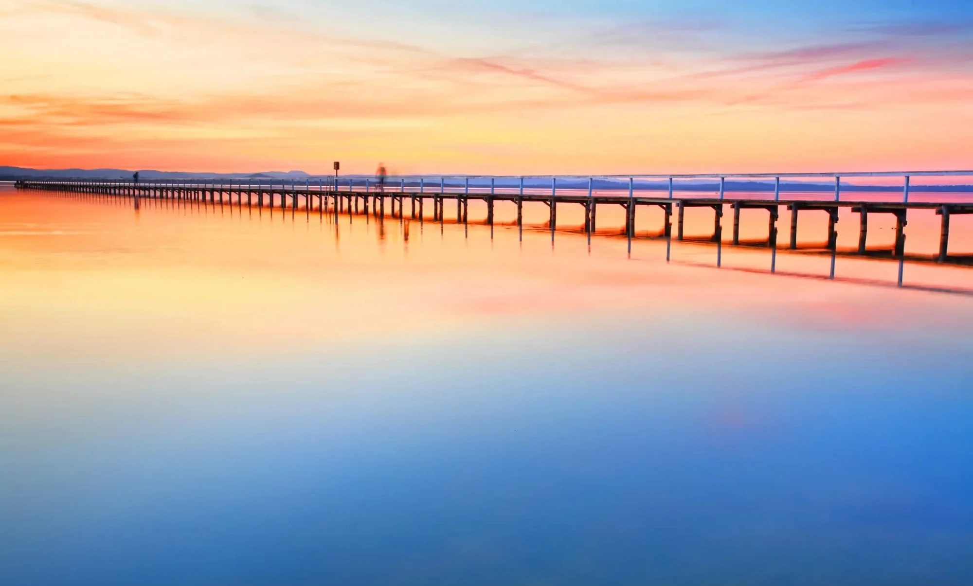Long Jetty boardwalk at sunset with calm reflective water on the Central Coast