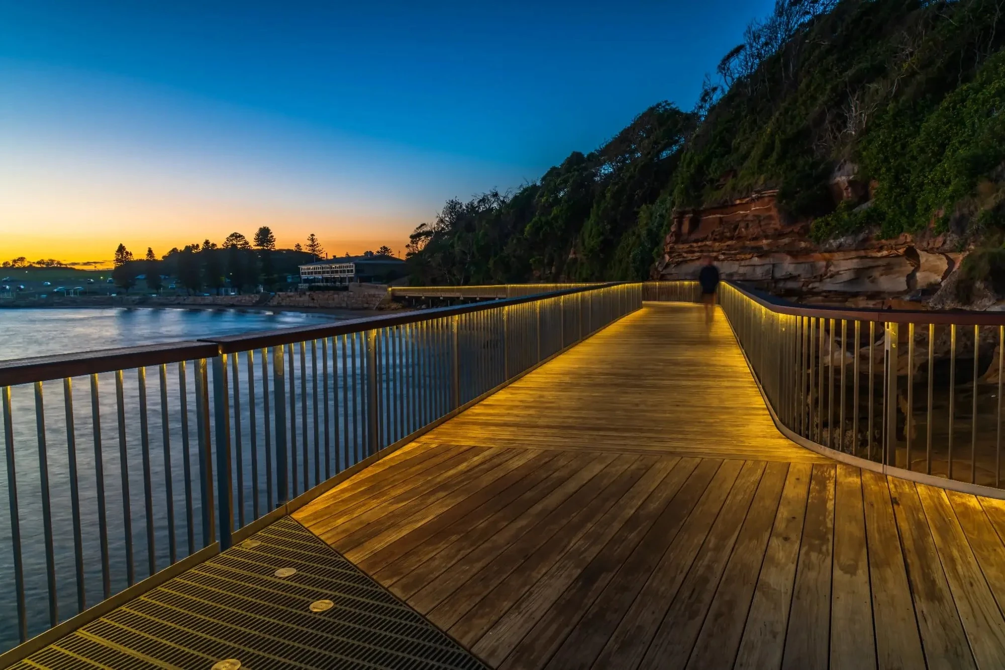 Terrigal Boardwalk illuminated at dusk with warm handrail lights and ocean views on the Central Coast, NSW
