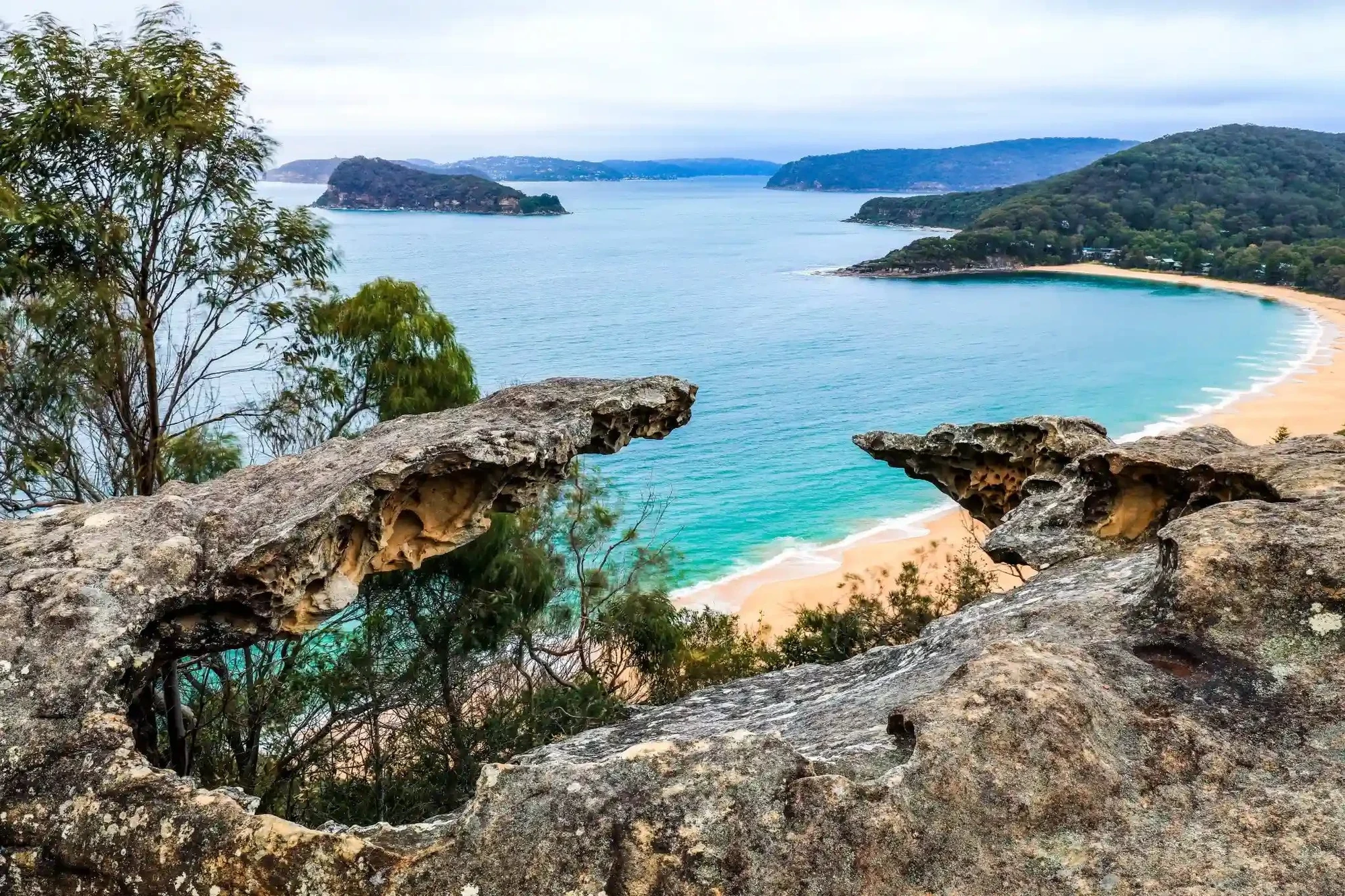 View from a rocky lookout over turquoise water at Pearl Beach on the Central Coast, NSW